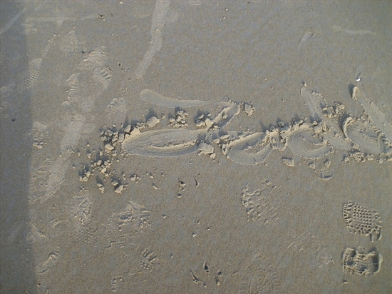 Todd drew his name in the sand with his shoe.
